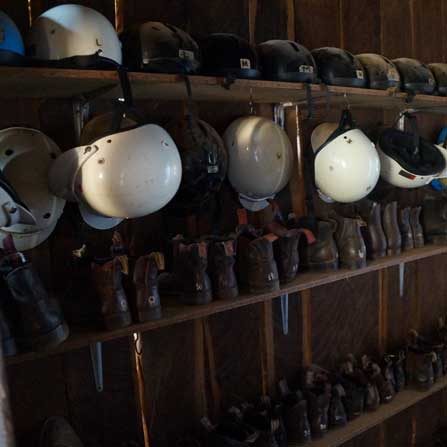 rows of riding helmets and riding boots